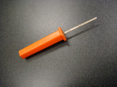 This thin saw is found in many pumpkin kits. It has use when needing to gently remove parts of the rind completely.